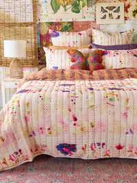 Bedroom with floral bedding and wall art